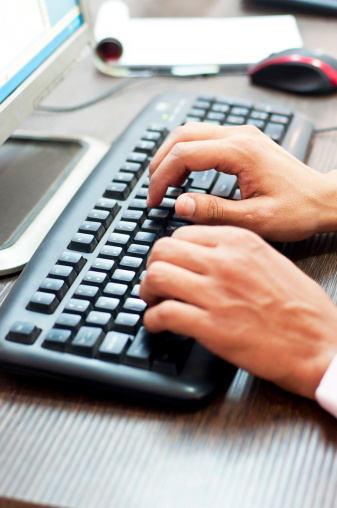 Businessman typing fingers on a keyboard