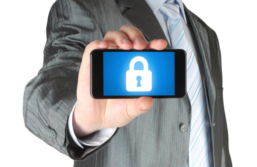 Businessman holds smart phone with closed lock