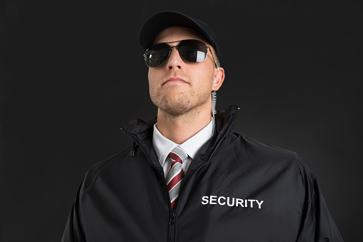 Bodyguard Wearing Sunglasses And Earpiece