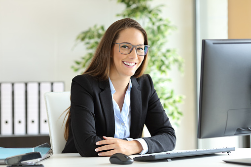 Businesswoman with glasses posing at office